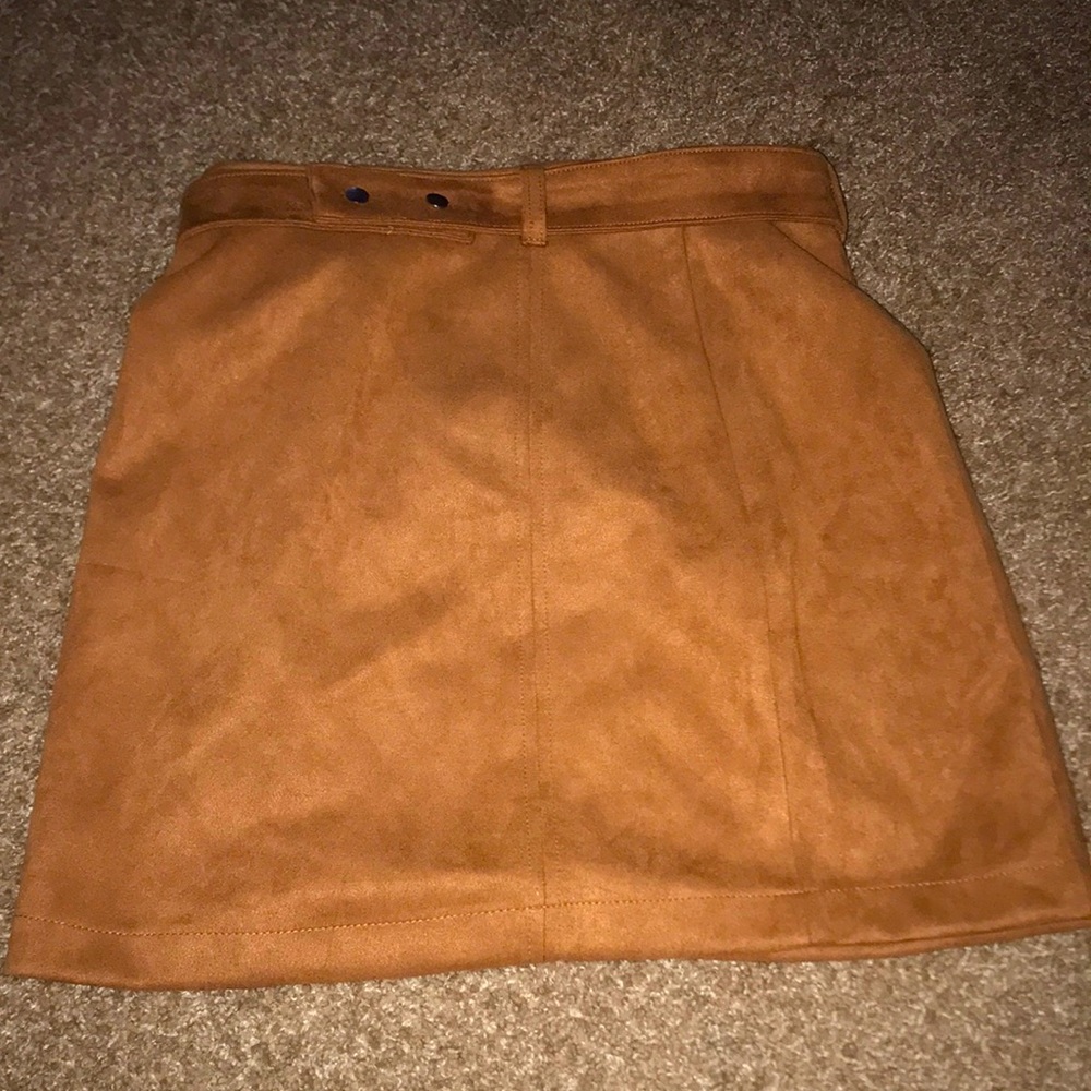 A tan/orangish skirt, thigh length, the size says large but closer to medium